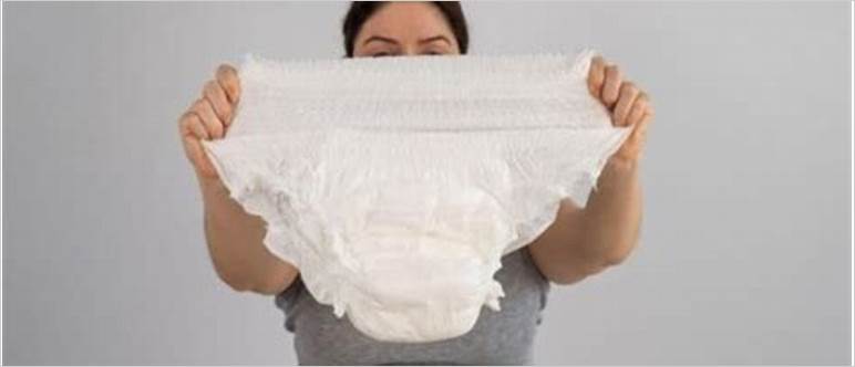 Woman peeing in diaper